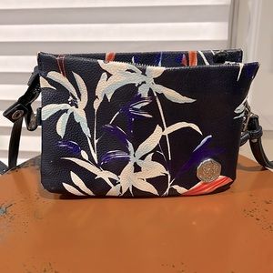 Crossbody convertible wristlet faux leather floral bag.